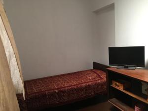 a small room with a bed and a flat screen tv at Bolgoda wind 