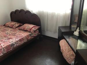 a bedroom with a bed and a dresser and a mirror at Bolgoda wind 