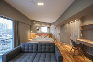 a bedroom with a large bed and a large window at ZDT-511 in Tokyo