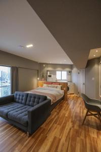 a large bedroom with a bed and a couch at ZDT-511 in Tokyo