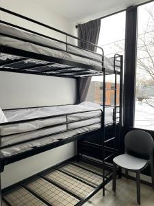a room with two bunk beds and a chair at Q FOX BLACK DIAMOND HOTEL in Niseko