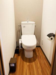 a bathroom with a toilet with a wooden floor at Q FOX BLACK DIAMOND HOTEL in Kutchan +15 photos