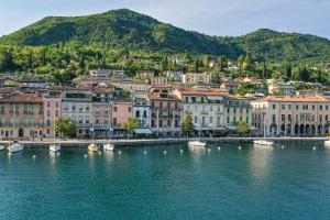 a group of buildings on the shore of a body of water at BELVEDERE - Garda Leisure in Salò