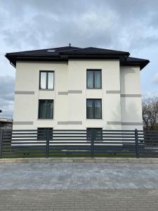 a white building with a black roof at Willa K52 in Siemiatycze