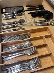 a drawer filled with silver utensils on a table at Simplicity Stays NOLA in New Orleans