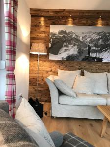 a living room with a white couch and a table at 5 Sterne Chalet Bergsuite in Oberstaufen