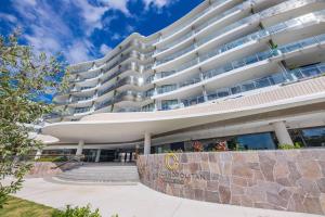 a large white building with stairs in front of it at RIVERVIEWS@THECOSMOPOLITAN UNIT20805 in Maroochydore