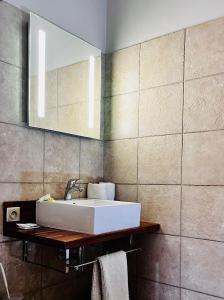 W łazience znajduje się umywalka i lustro. w obiekcie Le Passiflore w mieście Koumac
