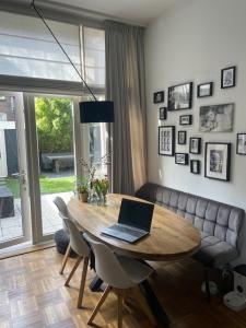 a laptop sitting on a wooden table in a living room at De Boetz in The Hague