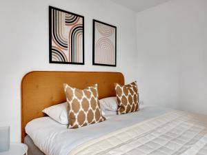 a bed with two pillows on top of it at Sanders Constantin - Chic Two-Bedroom Apartment With Balcony in Copenhagen