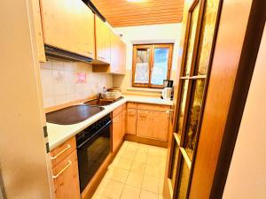 a small kitchen with a sink and a stove at Ferienwohnung Bergsonne mit Oberstaufen Plus in Oberstaufen