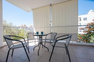 a balcony with a table and chairs on a balcony at Glabur Stays - The Master Atelier - Nicosia City, Free Parking & Wifi, Welcomes You!!! in Nicosia