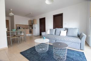 a living room with a blue couch and a kitchen at Glabur Stays - The Master Atelier - Nicosia City, Free Parking & Wifi, Welcomes You!!! in Nicosia