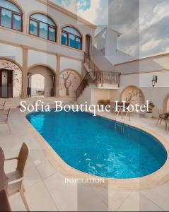 a large swimming pool in a villa with a house at SOFIA BOUTIQUE HOTEL in Kyrenia