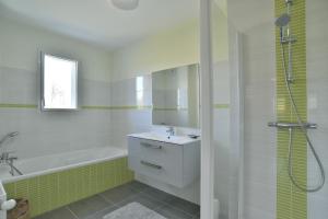 bagno con lavandino, vasca e doccia di Les Figuiers - Joli maison pour 8 a Plouër-sur-Rance