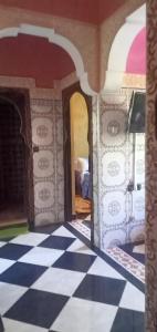 a room with a black and white checkered floor at Dar LBAHJA 3 in Ouzoud