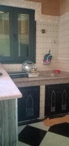 a kitchen with a sink and a counter top at Dar LBAHJA 3 in Ouzoud