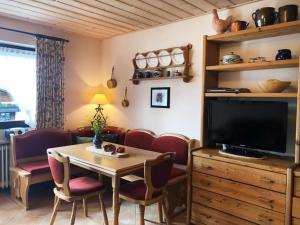 een woonkamer met een tafel en een televisie bij Ferienwohnung Jessen in Oberstaufen