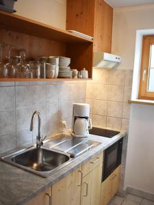 a kitchen with a sink and a coffee maker at Ferienwohnung Mack in Oberstaufen