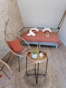 a room with two chairs and a bed at Sophie LE FEUVRE - Soins Energétiques in Baugé-en-Anjou