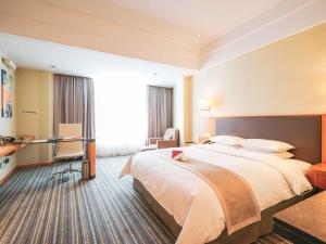 a hotel room with a large bed and a desk at Ramada Plaza Shanghai Pudong Airport - A journey starts at the PVG Airport in Shanghai