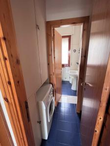 a small bathroom with a washer and dryer in it at Nunzia - Trilocale con terrazzo vista mare e doppi servizi in Sirolo
