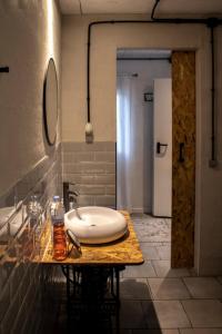 a bathroom with a white sink on a counter at Casa Mas Montañas - Gris in Godelleta