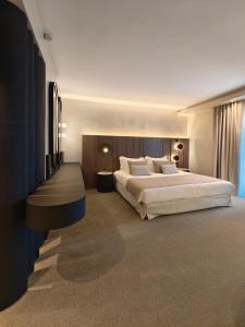 a bedroom with a large bed and a large window at Anatolia Hotel Komotini in Komotini