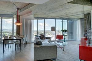 a living room with a couch and a table at Les Immeubles Charlevoix - Le 760-612 in Quebec City +16 photos