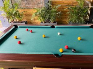 a pool table with balls on top of it at Location saisonniere villa l arosatier in Hell-Bourg