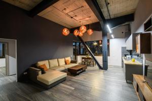 a living room with a couch and a table at ArtHomes Apartments in Timişoara