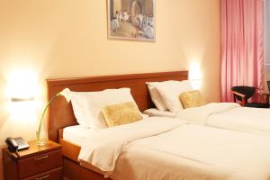 Un pat sau paturi într-o cameră la Hotel Rex