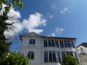 a white building with a blue sky in the background at Haus Saxonia in Binz