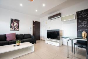 a living room with a couch and a tv at Glabur Stays - The Amazing 2 BDR - Nicosia City, Free Parking & WiFi in Nicosia
