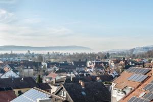 a city with solar panels on the roofs at Bodenseepanorama Oberuhldingen in Uhldingen-Mühlhofen