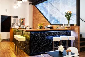 a bar in a restaurant with a large window at Art Hotel Like in Zagreb