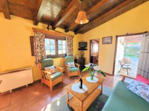 a living room with a couch and chairs and a table at Finca Llano de la cebolla in Icod de los Vinos