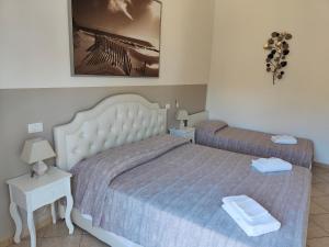 A bed or beds in a room at Residence Hotel Vittoria