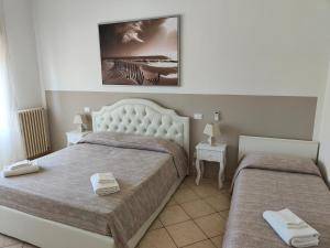 A bed or beds in a room at Residence Hotel Vittoria