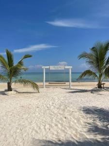 a beach with two palm trees and a goal at You&Me Resort in Koh Rong Island