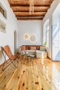 a living room with a couch and a table at Seablue Town Maisonette Mykonos in Mýkonos City