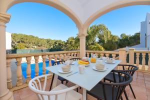 a table with cups and bananas on a balcony at Monte Blanco in Jávea