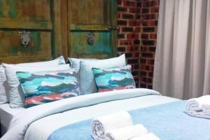a bedroom with two beds with pillows at Spindrift Seaside Accommodation in Wilderness +37 photos