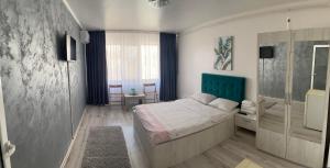 a small bedroom with a bed and a window at Garsoniera Centru in Galaţi