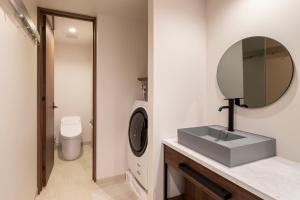 a bathroom with a sink and a mirror at Tokyu Stay Shinjuku Eastside in Tokyo