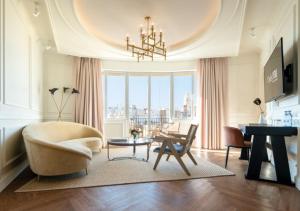 a living room with a chandelier and a couch and a table at Only YOU Hotel Valencia in Valencia