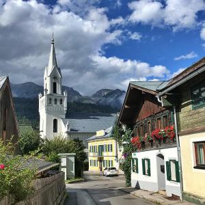 a small town with a white church and a lake at Finest Retreats - Haus Sophie in Schladming