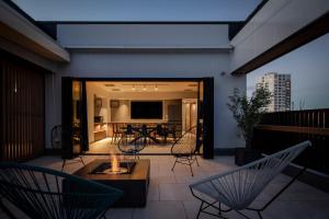 a patio with chairs and a table on a balcony at Tokyu Stay Shinjuku Eastside in Tokyo