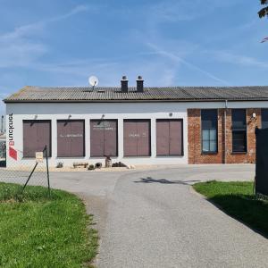 a building with windows on the side of it at Louise´s Camper in Neusiedl an der Zaya