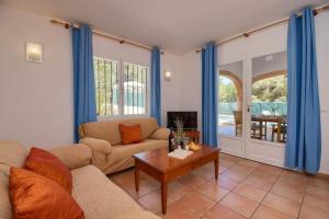 a living room with a couch and a table at Monte Naranja in Jávea